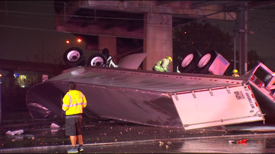 Semitruck goes off bridge onto DART tracks