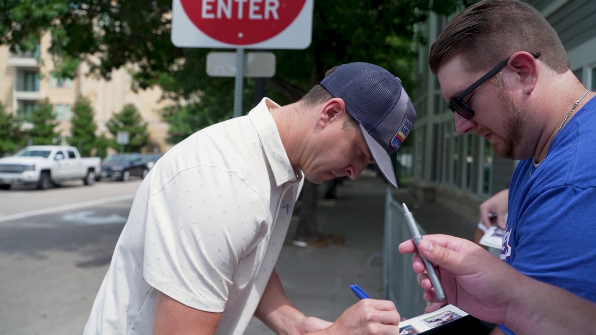 The Texas Rangers ace signs autographs for fans outside of the Frisco RoughRiders' stadium before his first start since tearing his UCL in April 2023.