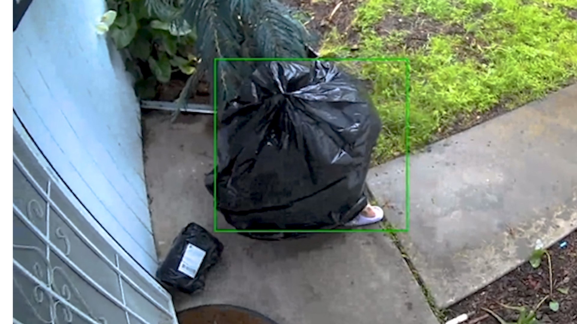 A person can be seen crouched inside a trash bag, slowly waddling to Omar Munoz's doorstep, picking up a small package and waddling away.