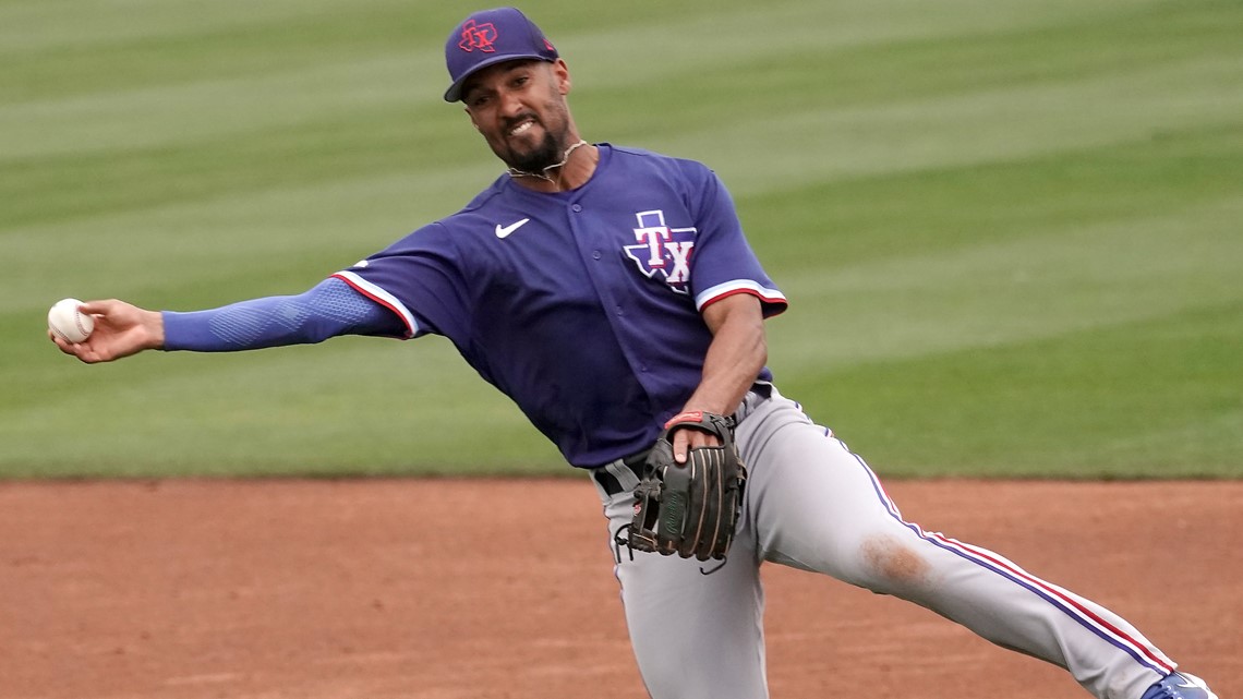 Texas Rangers right fielder Kole Calhoun throws during the second inning of  a spring training baseball game against the Seattle Mariners Monday, March  28, 2022, in Peoria, Ariz. (AP Photo/Charlie Riedel Stock