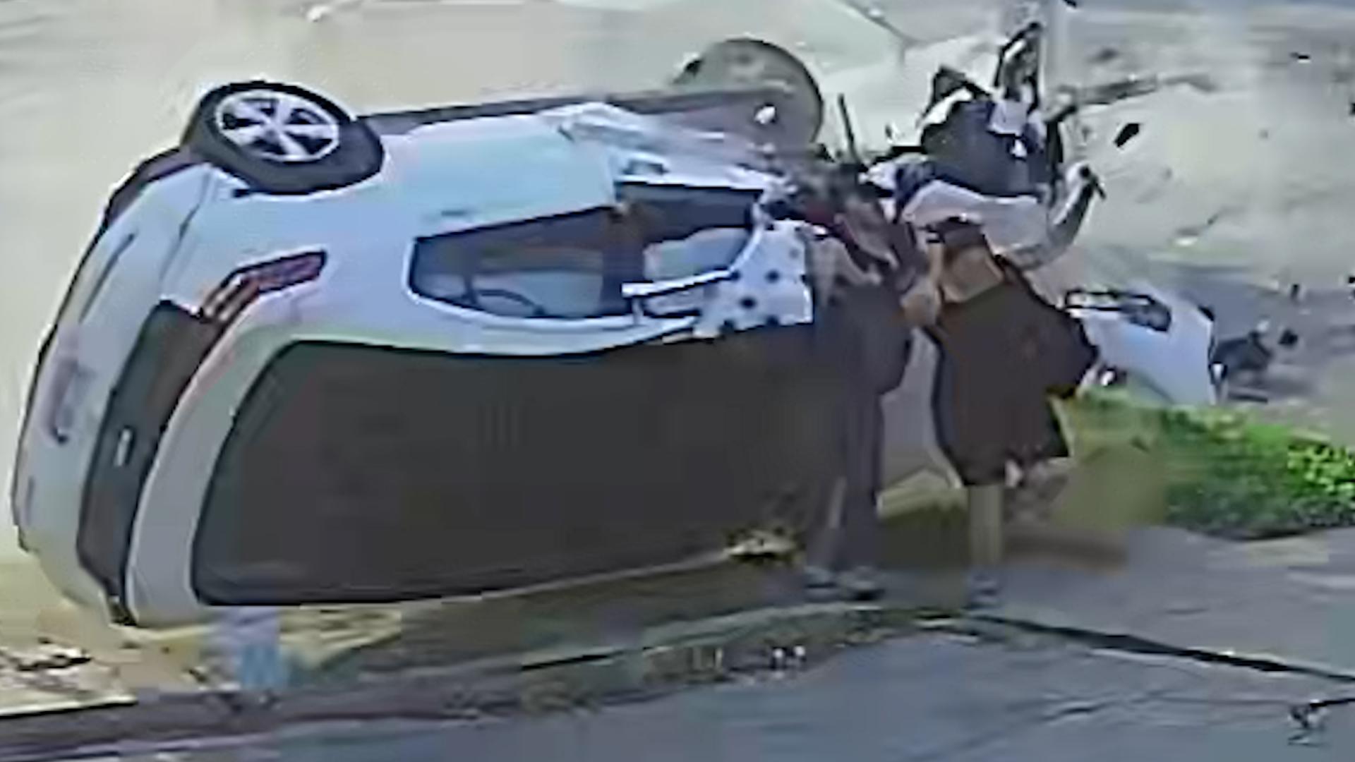 Footage from a bakery captures the moment two pedestrians are hit by a rolling car after a collision. All people walked away with minor injuries.