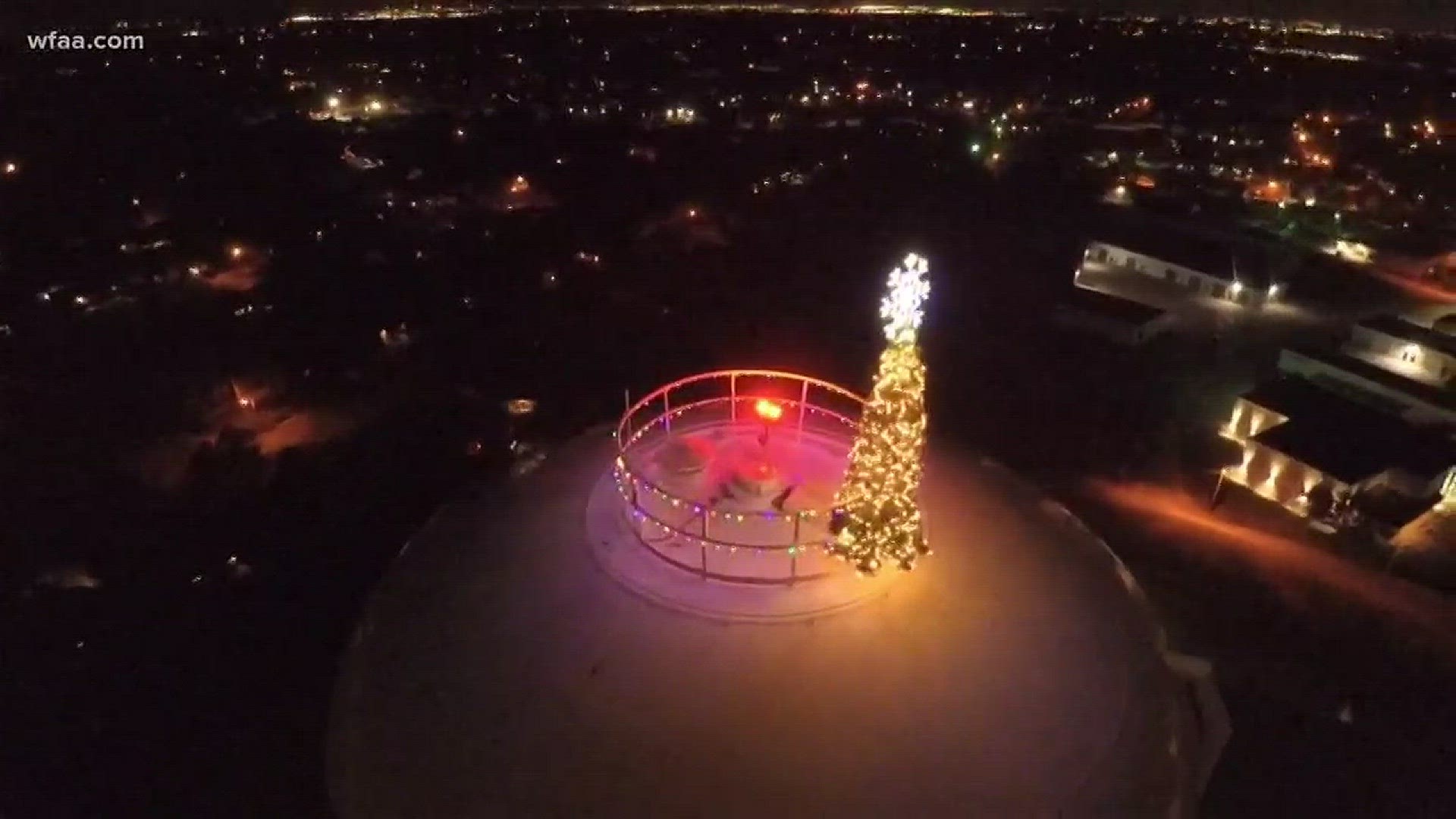 Tree tops water tower in quirky holiday decoration in Pantego