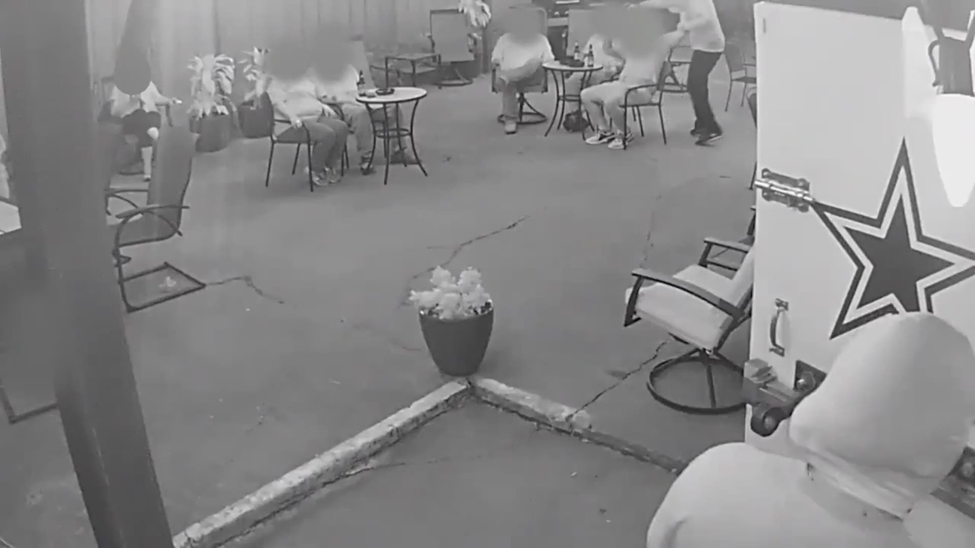 Surveillance video released by Fort Worth police shows suspect robbing the Los Vaqueros bar just before an officer was shot early Friday.