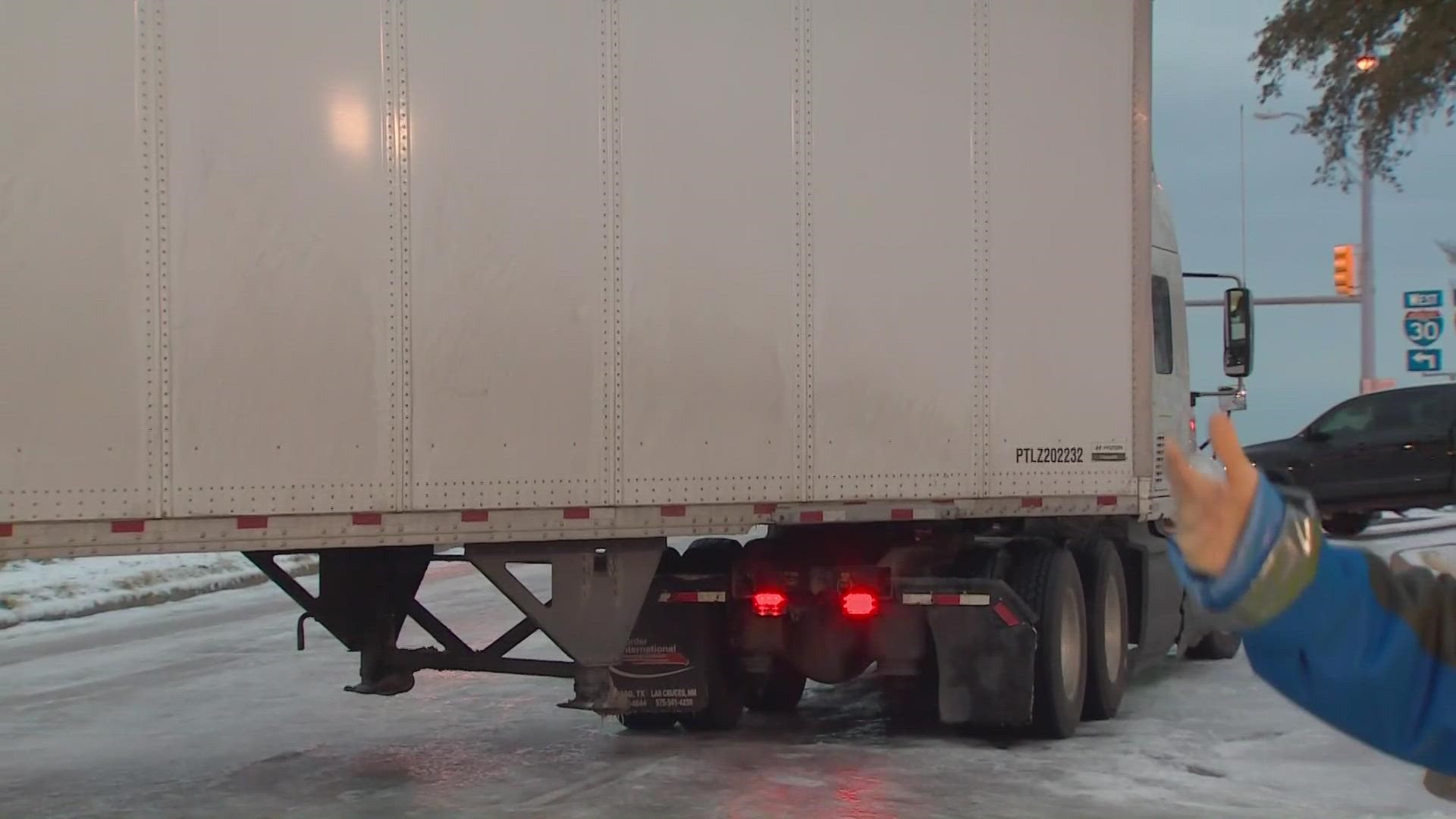 WFAA reporter Megan Mitchell gives tips on handling icy roads as a stuck 18-wheeler causes traffic in the Fort Worth area.