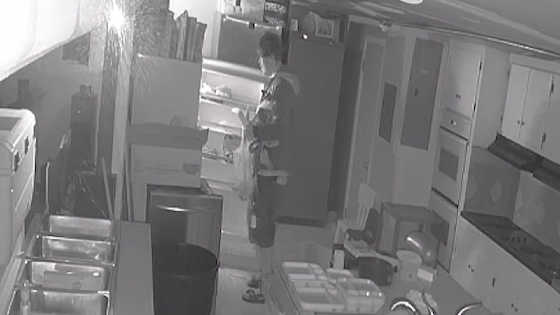 Surveillance video shows the thief break through a stained glass window, steal paperwork, raid the kitchen and empty soda cans into an empty milk jug.