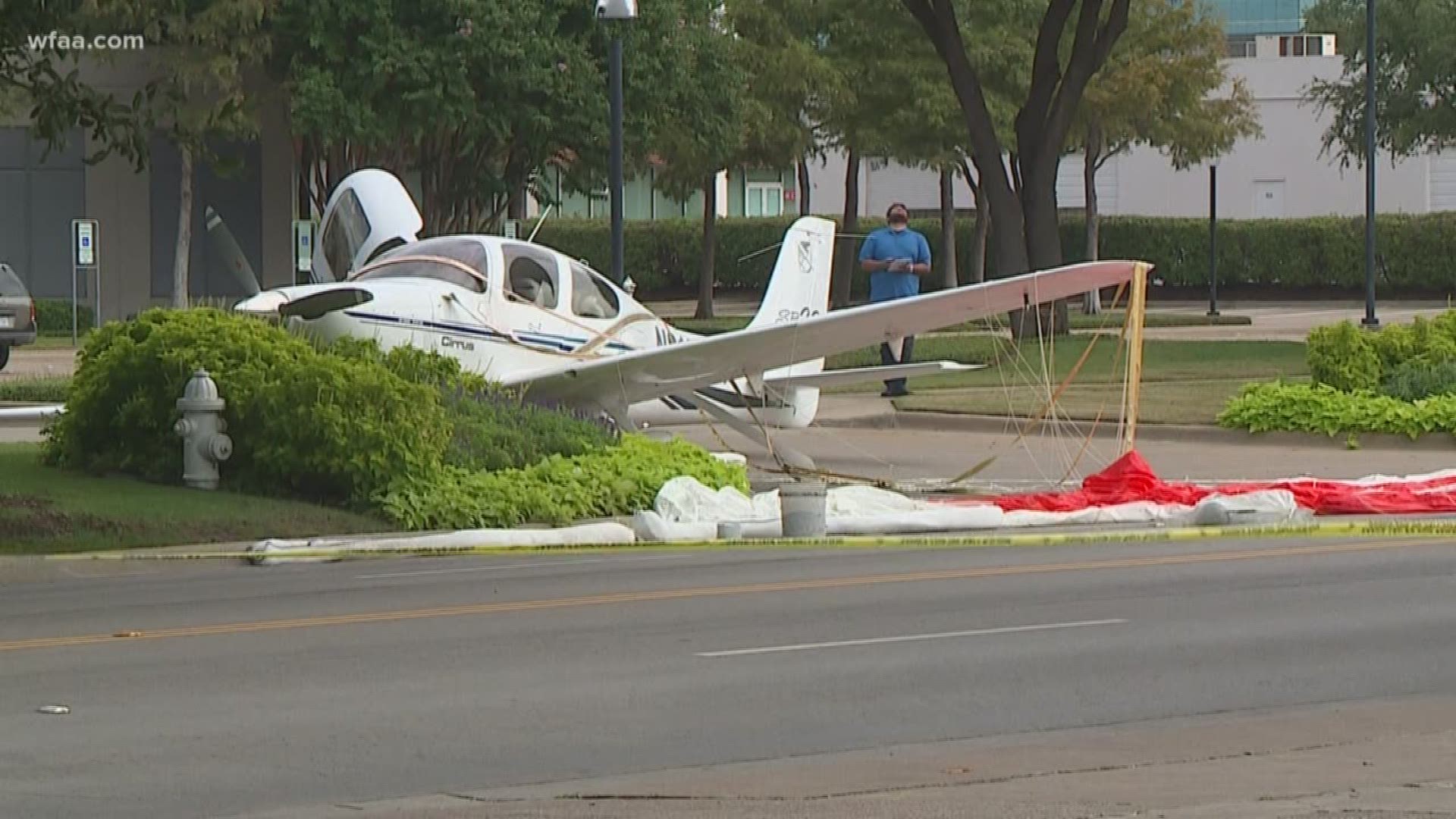 The FAA said the pilot deployed the Cirrus' emergency parachute with the plane coming to rest about a mile and a half south of the airport.
