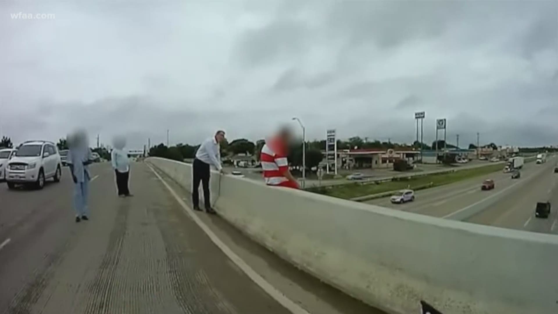 Officer pulls man from edge of overpass