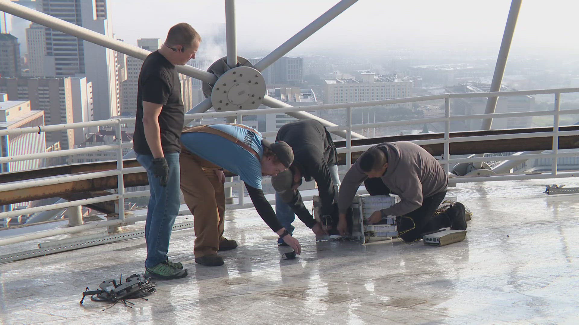 Crews are working to  install fireworks on Reunion Tower in downtown Dallas for the annual New Year's Eve fireworks display.