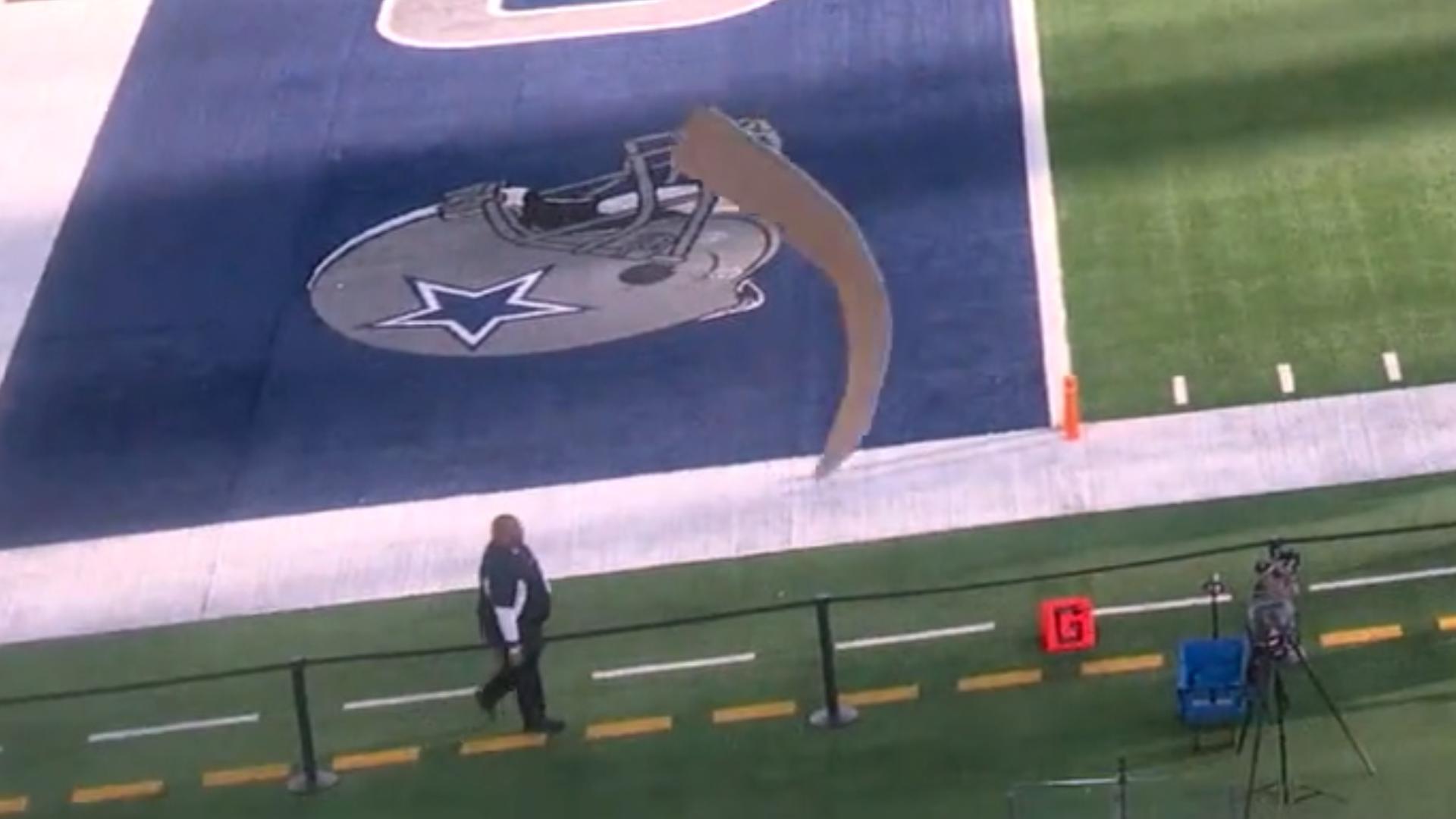 A piece of metal fell from the roof of AT&T Stadium after the team opened it for the first time in over two years. No one was injured.