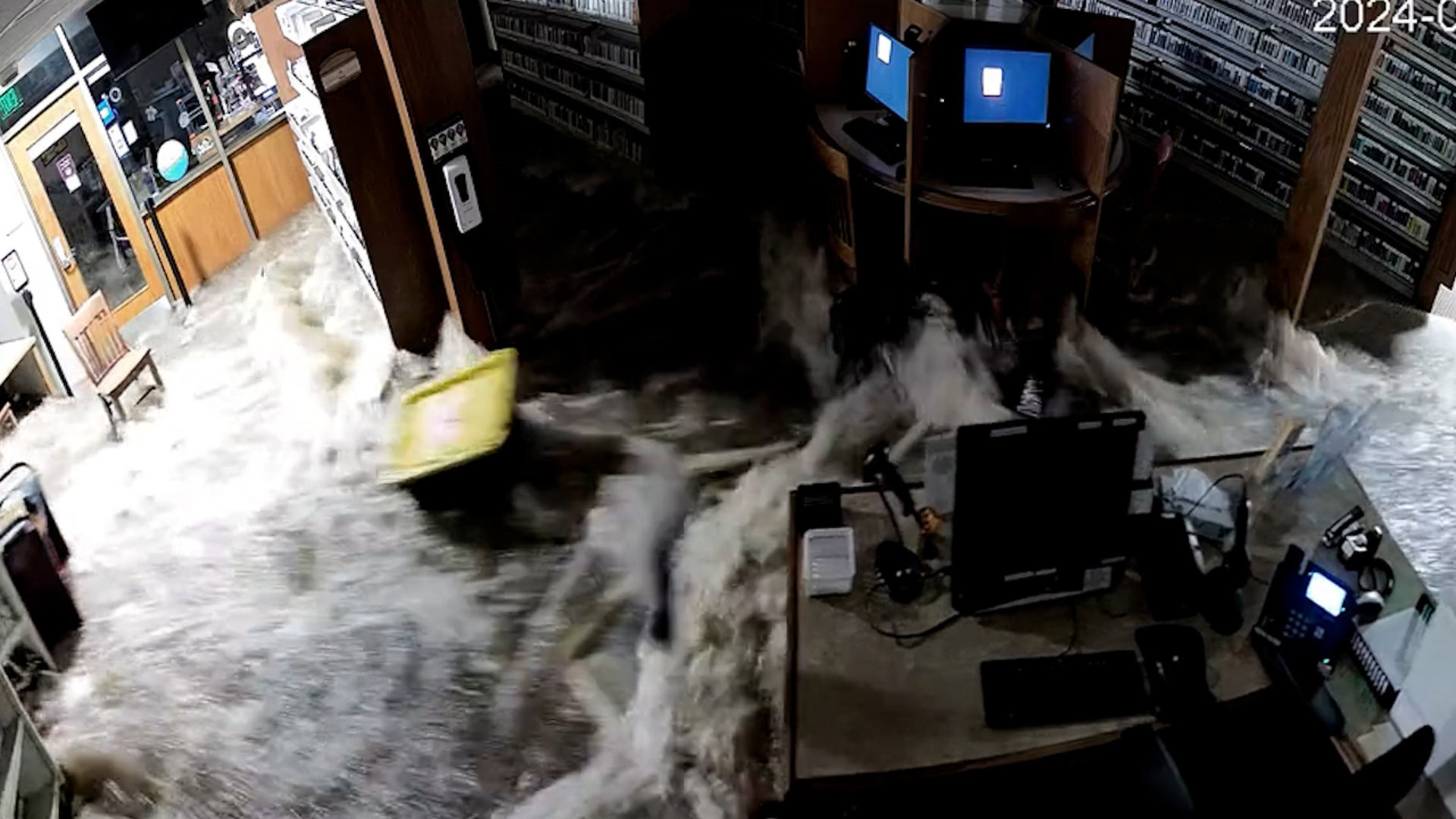 Smithtown Library in Long Island, New York, flooded on August 19. Surveillance video captured the moment water overtook the building.