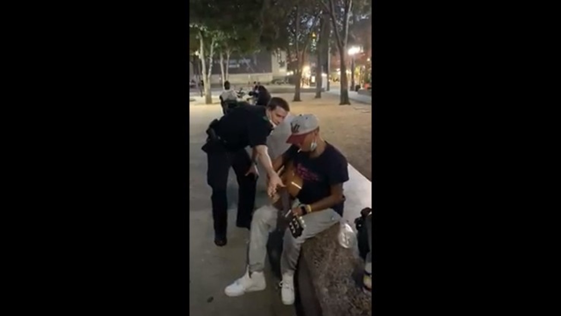 Officer Trainee Michael Morey II wanted to experience community policing on July 4. One moment with a reluctant resident shifted as Morey picked up her guitar.
