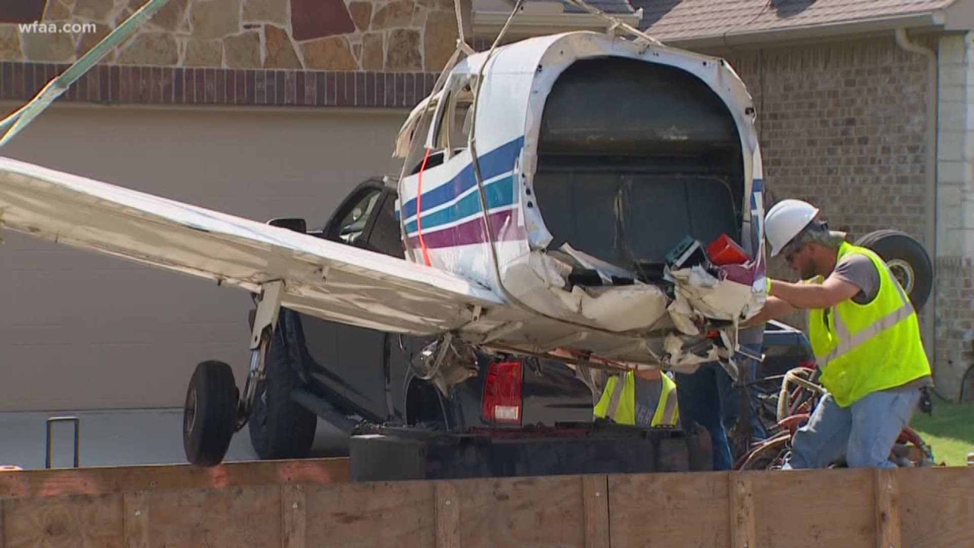 After a plane crashed into a McKinney home, a crane removed the aircraft Saturday from the backyard.