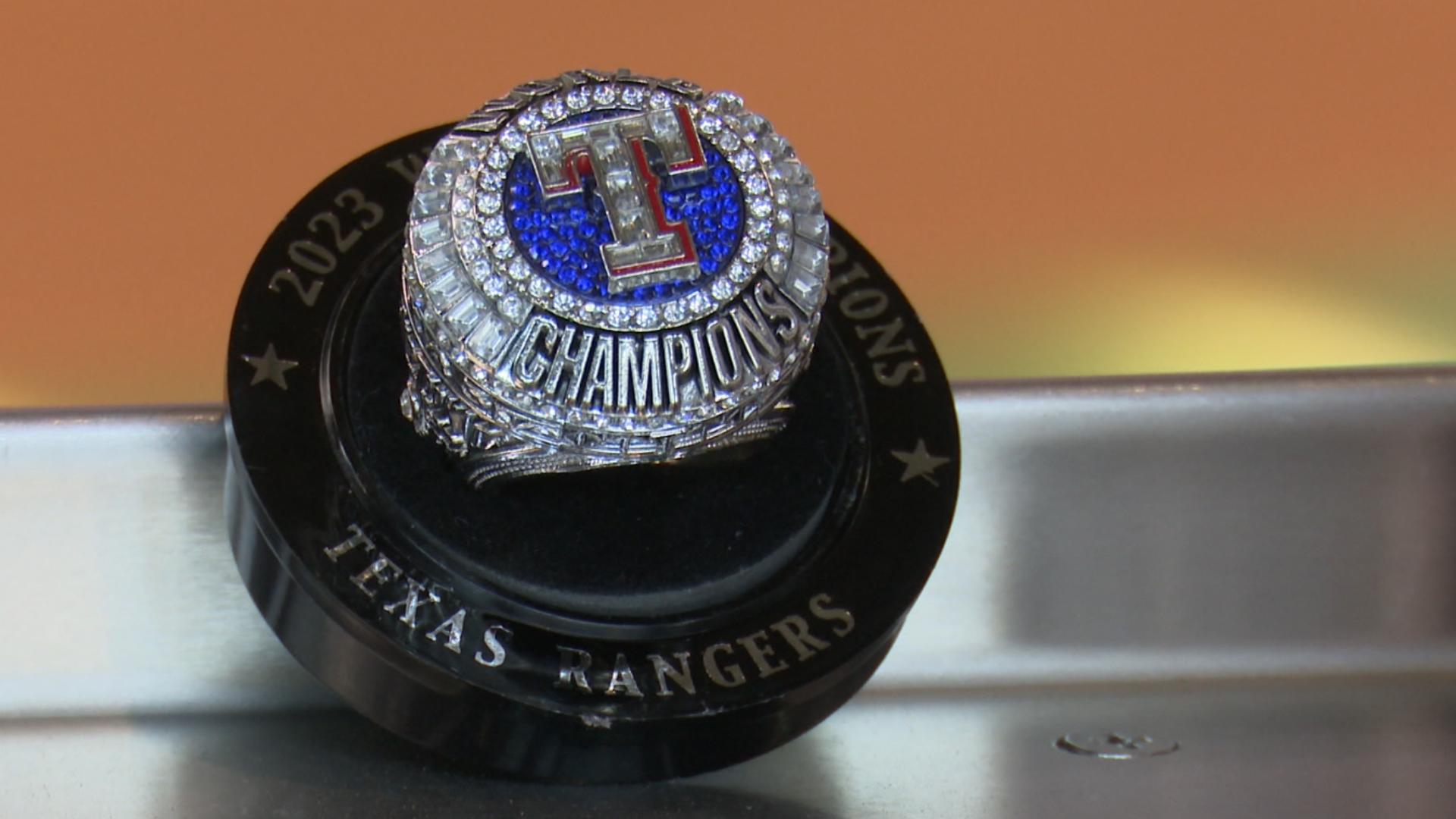 Chris Sadeghi has a look at the Texas Rangers World Series replica ring the club is giving away.