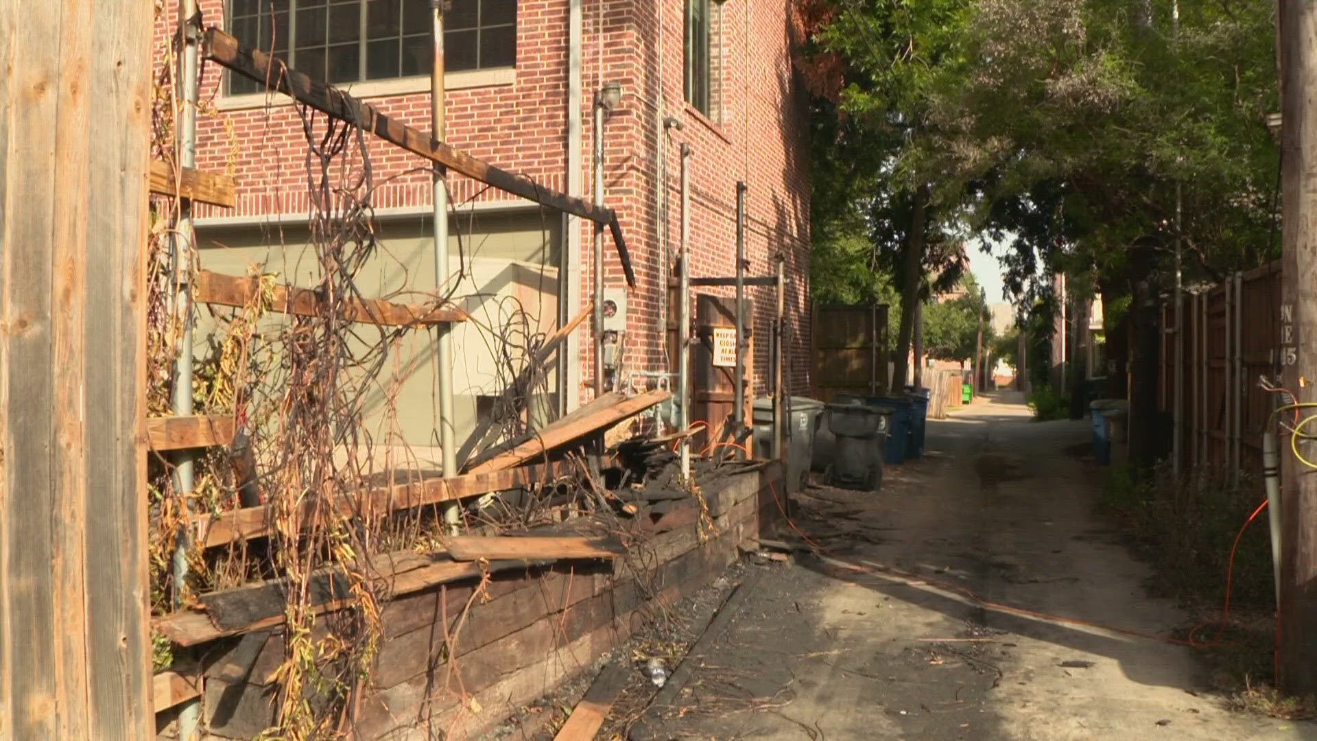 Security footage shows two people walking away from the fence before it goes up in flames. Investigators with Dallas Fire-Rescue are looking over the footage.