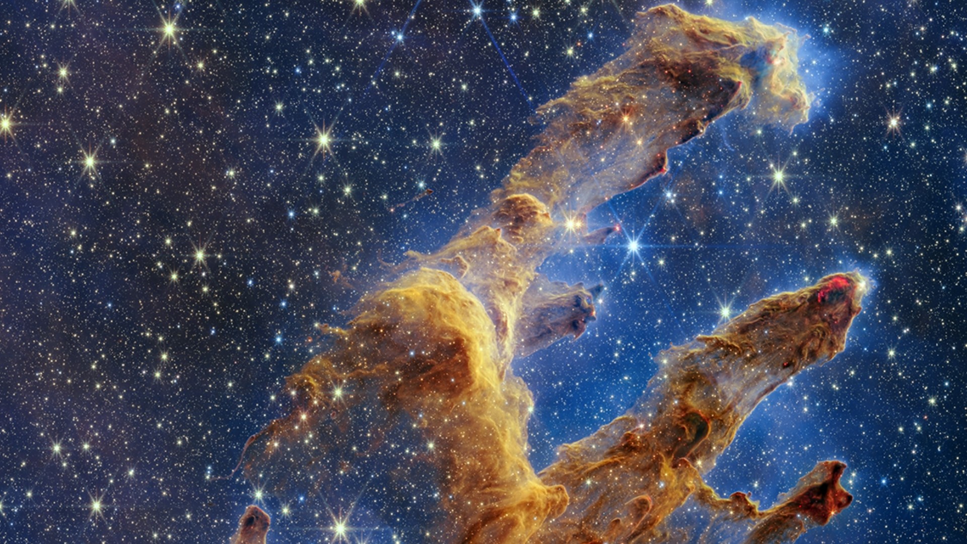 The star-studded new image captures the famed pillars in near-infrared light, allowing NASA's Webb telescope to see thousands of newly-formed stars.